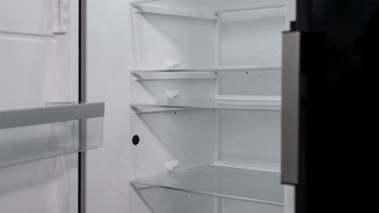 Open commercial refrigerator interior showing shelving inside