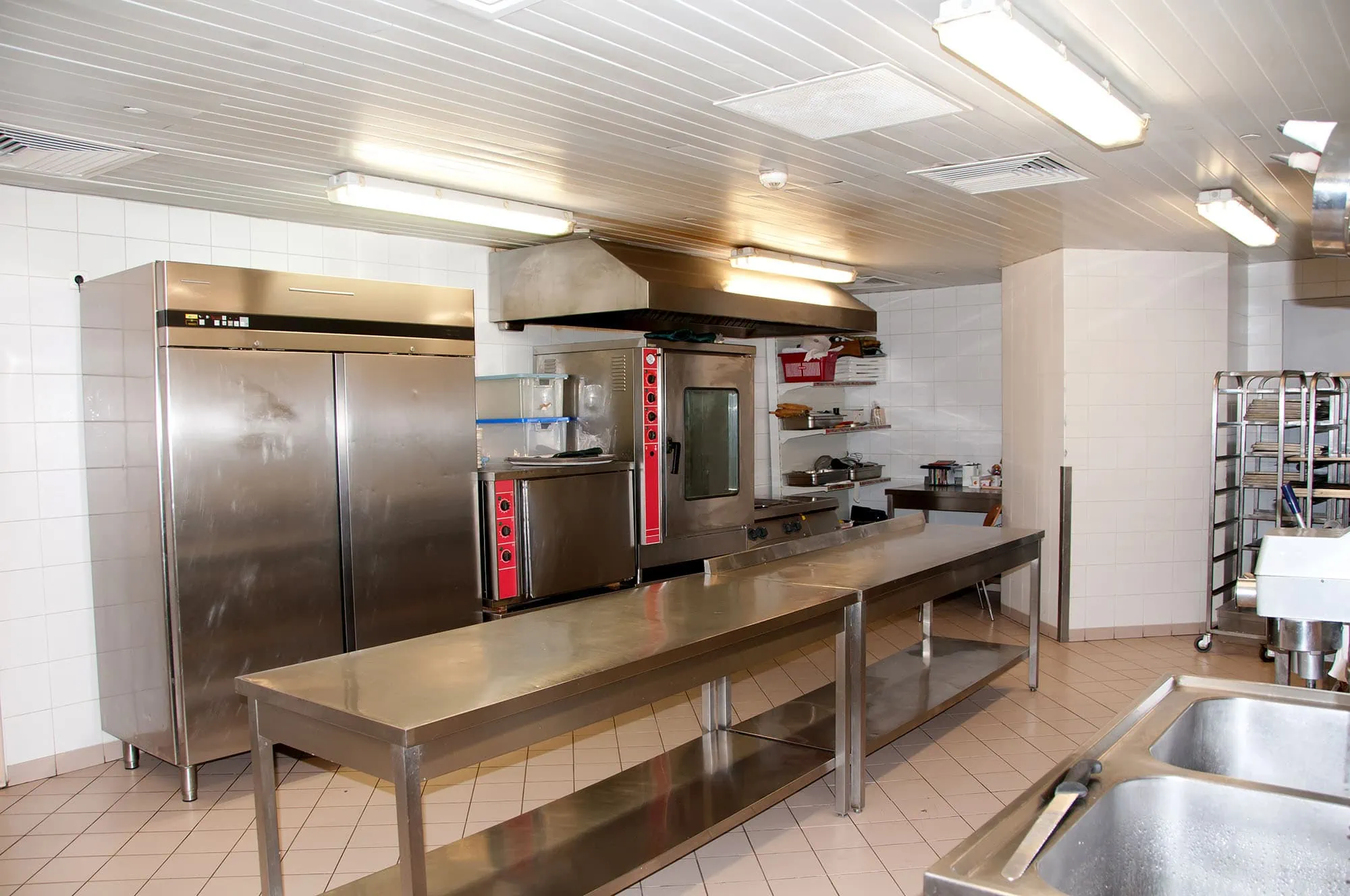 Restaurant kitchen with commercial fridge and appliances