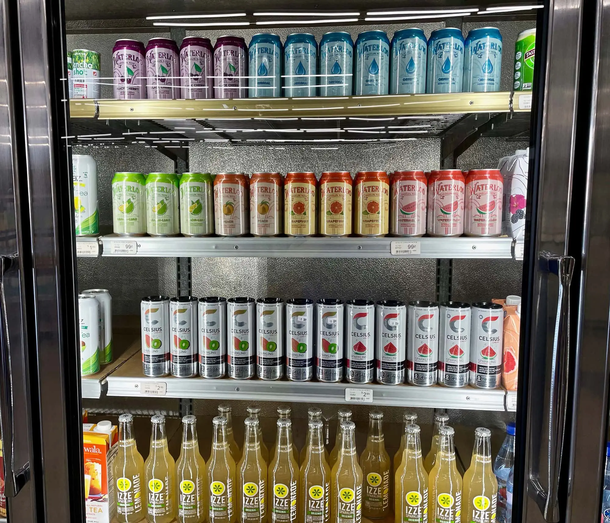 Drinks neatly organised inside a glass display fridge