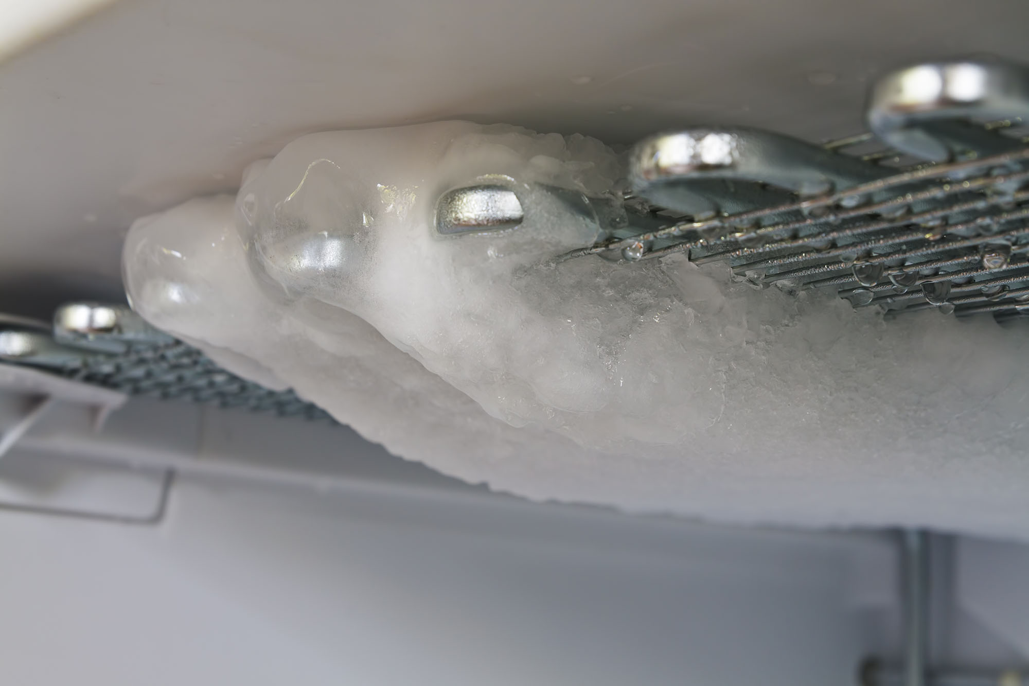 Evaporator coils frozen over with ice and defrosting