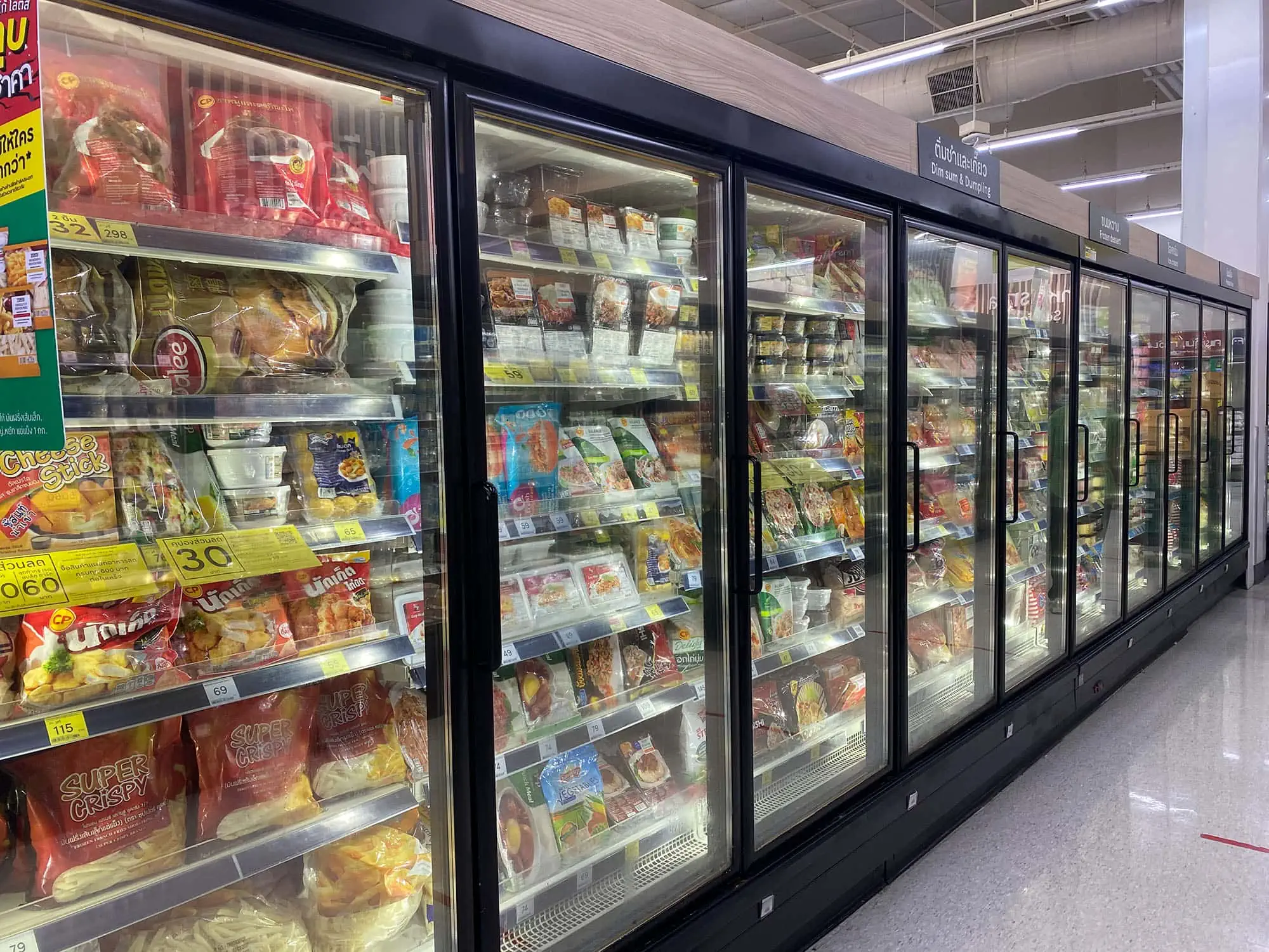 Row of glass door display fridges in a supermarket